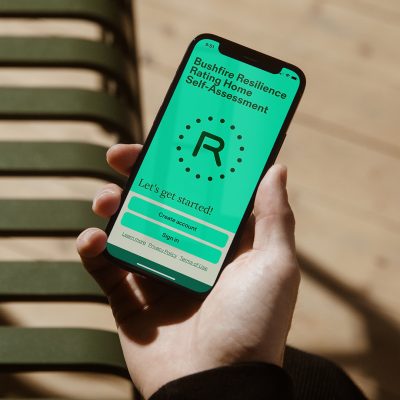 picture of a mobile phone with the Bushfire Resilience Rating Home Self-assessment app open on the screen